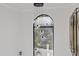 Bright foyer features a modern chandelier, arched window, and unique metal wall art at 8020 Sharon Dr, Tampa, FL 33617