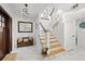 Bright foyer with light wood stairs, modern chandelier, and white marble floors create a welcoming entrance to this home at 8020 Sharon Dr, Tampa, FL 33617
