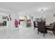 Bright living room with open floor plan, marble tile floors, and eat-in kitchen with island at 8020 Sharon Dr, Tampa, FL 33617
