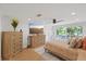 Spacious main bedroom with stylish furniture, a large TV, and a view of the outdoors at 8020 Sharon Dr, Tampa, FL 33617