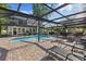 This screened pool is surrounded by brick pavers, a screened lanai, and a nice view of the backyard at 8020 Sharon Dr, Tampa, FL 33617