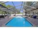 Refreshing pool area enclosed in a screen, complemented by a brick patio and outdoor furniture at 8020 Sharon Dr, Tampa, FL 33617