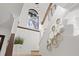 Modern staircase with light wood steps, decorative wall mirrors, and a large window at 8020 Sharon Dr, Tampa, FL 33617