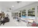 Bright sunroom with large windows overlooking the pool and lush backyard, providing a peaceful retreat inside this home at 8020 Sharon Dr, Tampa, FL 33617