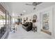 Bright sunroom with marble floors, ceiling fans, and a comfortable leather reclining sofa set at 8020 Sharon Dr, Tampa, FL 33617
