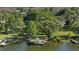 An aerial view of the house on the water with boat dock in the backyard, and lush greenery surrounding the property at 8020 Sharon Dr, Tampa, FL 33617