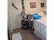 Bedroom showcasing a nightstand with a lamp, floral themed bedding, and assorted wall decor at 8119 Oak Trace Way # C, Tampa, FL 33634
