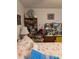 Bedroom featuring shelving decoratively displaying teddy bears, lamps and floral themed pictures at 8119 Oak Trace Way # C, Tampa, FL 33634