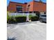 Two-story townhome featuring a red tile roof, balcony, and white fence at 8119 Oak Trace Way # C, Tampa, FL 33634