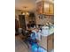 View of the kitchen and desk with oak cabinets, tile floors, and standard appliances at 8119 Oak Trace Way # C, Tampa, FL 33634