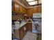 Traditional kitchen with oak cabinets and standard white appliances at 8119 Oak Trace Way # C, Tampa, FL 33634