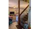 View of living room with staircase, carpeted floor, ceiling fan, and mirrored wall at 8119 Oak Trace Way # C, Tampa, FL 33634