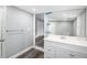 Bathroom with new white vanity, large mirror, and updated fixtures at 8624 N Semmes St, Tampa, FL 33604