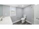 Updated bathroom features shower, toilet, vanity and new laminate floor at 8624 N Semmes St, Tampa, FL 33604