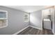 Bright bedroom with updated floors and a view to laundry room at 8624 N Semmes St, Tampa, FL 33604