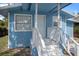 Closeup of the light blue home's entrance showing the front porch at 8624 N Semmes St, Tampa, FL 33604