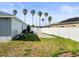 White fenced in backyard with a concrete pad and ample space for outdoor activities at 8702 Pinafore Dr, New Port Richey, FL 34653