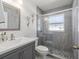 This bathroom has a tiled walk-in shower with glass door, with a sink and commode at 8702 Pinafore Dr, New Port Richey, FL 34653