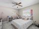 Bright bedroom with a ceiling fan, tile floors, and desk area is perfect for relaxation and study at 8702 Pinafore Dr, New Port Richey, FL 34653