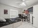This bedroom has a desk, chair, ceiling fan, and bed. Great use of space for a student or guest at 8702 Pinafore Dr, New Port Richey, FL 34653
