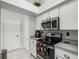 Efficient kitchen with stainless steel appliances, modern design, and adjacent pantry or storage closet at 8702 Pinafore Dr, New Port Richey, FL 34653