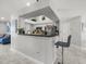 Open kitchen with breakfast bar, stainless appliances, and easy access to other living spaces at 8702 Pinafore Dr, New Port Richey, FL 34653