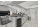 Open kitchen area with ample counter space, stainless steel appliances, and bar seating at 8702 Pinafore Dr, New Port Richey, FL 34653