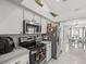 Well-lit kitchen featuring stainless appliances, modern finishes and seamless access to dining room at 8702 Pinafore Dr, New Port Richey, FL 34653