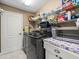 Convenient laundry room with modern washer and dryer and plenty of storage space on shelving at 8702 Pinafore Dr, New Port Richey, FL 34653