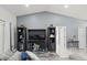 Living room with tile flooring, media center, and modern furnishings in a neutral color palette at 8702 Pinafore Dr, New Port Richey, FL 34653