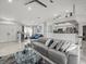 Open-concept living room showcasing tile floors, modern furniture, and lots of natural light at 8702 Pinafore Dr, New Port Richey, FL 34653