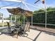 Entertain Gathering and friends on the covered patio, featuring a patio set and hammock at 8702 Pinafore Dr, New Port Richey, FL 34653