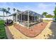 Enclosed patio features durable screens, offering a comfortable outdoor space surrounded by rock gardens at 8702 Pinafore Dr, New Port Richey, FL 34653