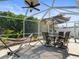 The covered patio is perfect for relaxing or entertaining with dining set and hammock at 8702 Pinafore Dr, New Port Richey, FL 34653
