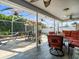 Enjoy the outdoors with this screened in lanai, featuring a patio set, ceiling fans, and seating at 8702 Pinafore Dr, New Port Richey, FL 34653