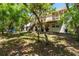 Charming home's backyard showcasing a beautiful deck surrounded by trees, blending indoor/outdoor living at 9019 Stone Dr, Webster, FL 33597