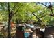 Inviting backyard wooden deck setting with comfortable chairs and a serene view of the wooded creek, ideal for relaxation at 9019 Stone Dr, Webster, FL 33597