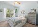 Bright bedroom with a window view, ceiling fan, and antique dresser at 9019 Stone Dr, Webster, FL 33597