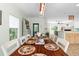 Cozy dining area showcasing a wooden table set for six, views of the kitchen, and inviting access to the living space at 9019 Stone Dr, Webster, FL 33597