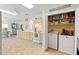 Convenient laundry closet including washer, dryer, and storage shelving within the kitchen area, great for easy access at 9019 Stone Dr, Webster, FL 33597
