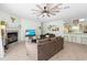 Cozy living room features fireplace, ceiling fan, and access to the kitchen bar at 9019 Stone Dr, Webster, FL 33597