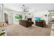 Spacious living room with fireplace, fan, and sliding glass doors to balcony at 9019 Stone Dr, Webster, FL 33597