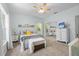 Comfortable bedroom with mirrored closet, ceiling fan, and bright natural light at 9019 Stone Dr, Webster, FL 33597