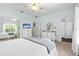 Bright main bedroom with a ceiling fan, lots of dresser storage, and mirrored closets at 9019 Stone Dr, Webster, FL 33597