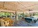 Finished outdoor living area with game space, picnic tables, and grilling station at 9019 Stone Dr, Webster, FL 33597