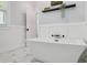 Beautiful bathroom with white soaking tub and geometric tile flooring at 906 E Patterson St, Tampa, FL 33604