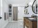 Bright bathroom features a patterned tile floor, vanity, and decorative shelves at 906 E Patterson St, Tampa, FL 33604