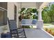 Inviting front porch with swing, rocking chair, and ample space for relaxation at 906 E Patterson St, Tampa, FL 33604