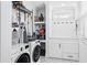 Bright laundry room featuring washer, dryer, storage, and a tiled dog washing station at 906 E Patterson St, Tampa, FL 33604