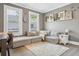 Bright living area with a comfortable sectional sofa, neutral colors, and stylish decor accents at 906 E Patterson St, Tampa, FL 33604